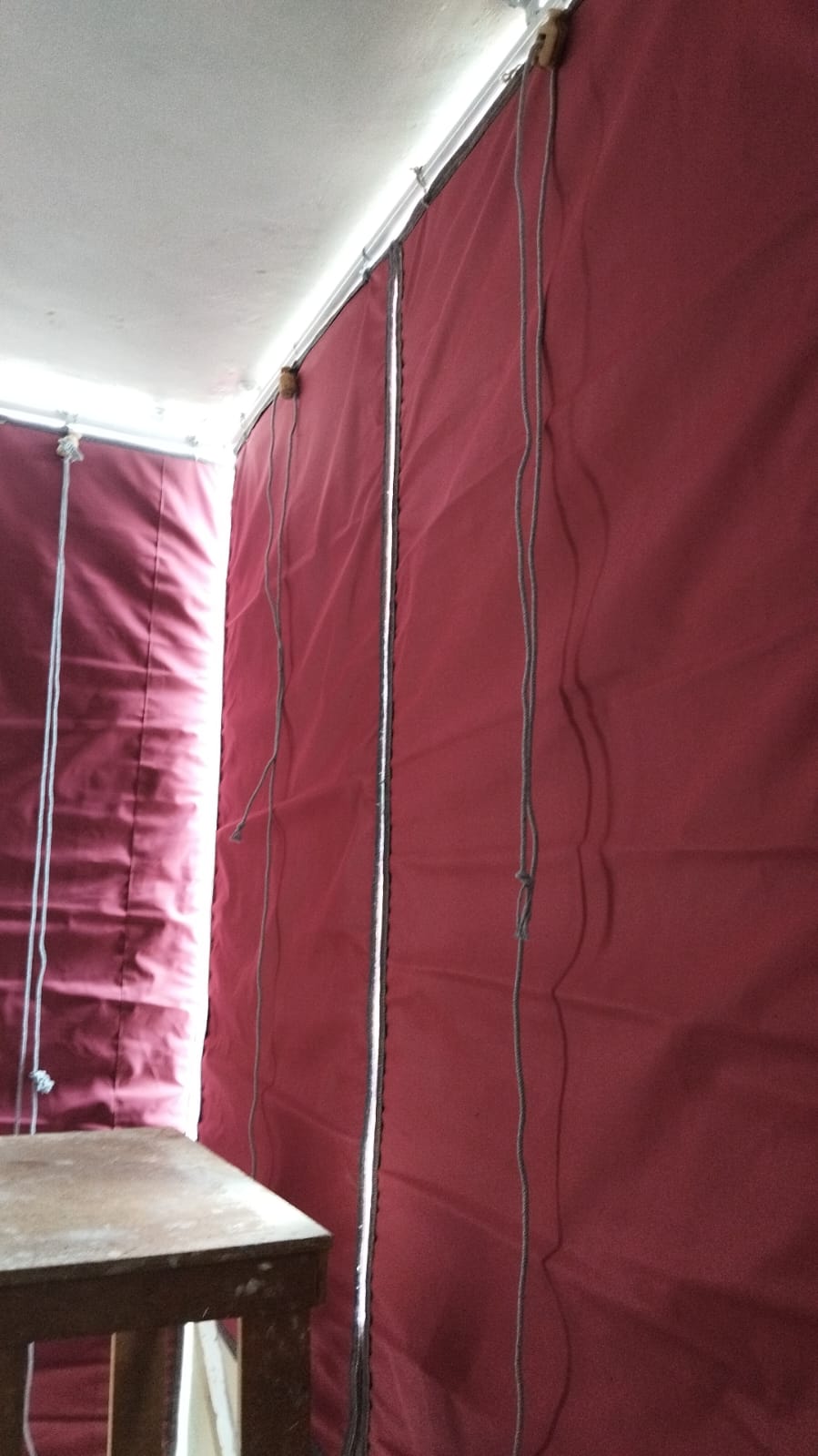 Real GPC bamboo chick blinds rolled halfway on a colonnaded verandah