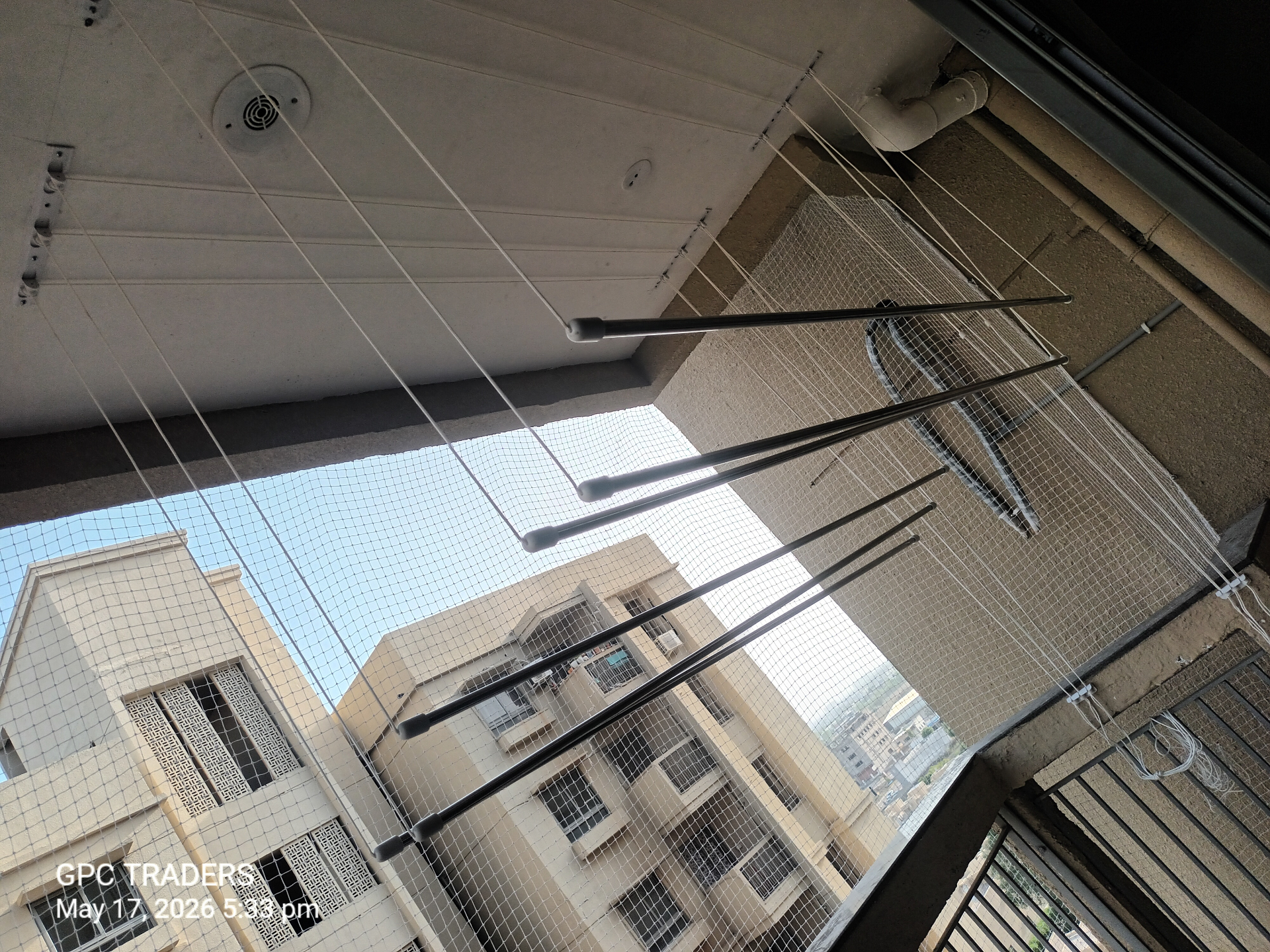 Ceiling-mounted cloth dryer hanger installed on a utility balcony