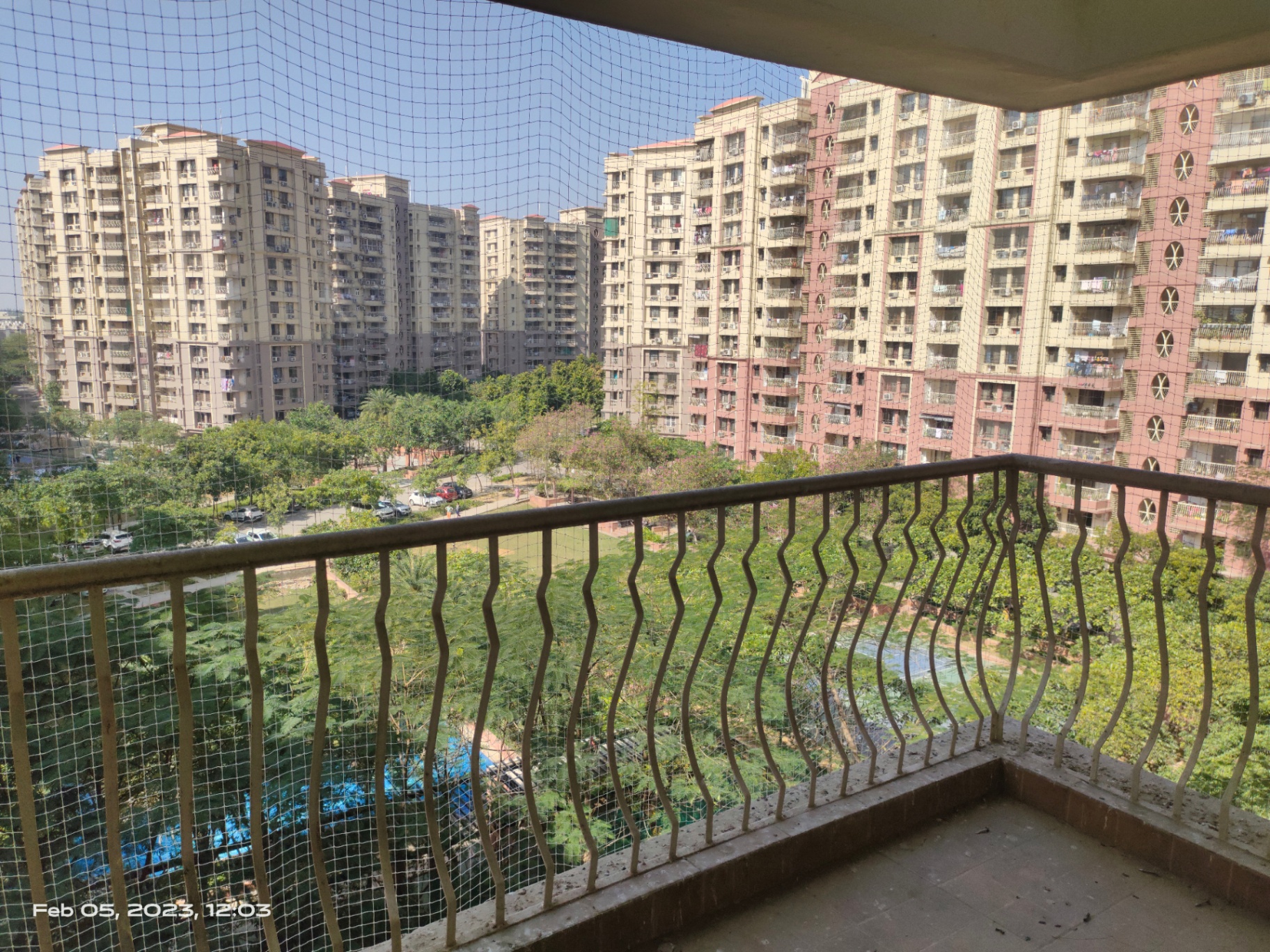 UV-treated pigeon net on a high-rise balcony with city skyline behind